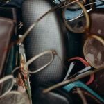 Swap Meet - Black and Brown Leather Bifold Wallet Beside Black Framed Eyeglasses