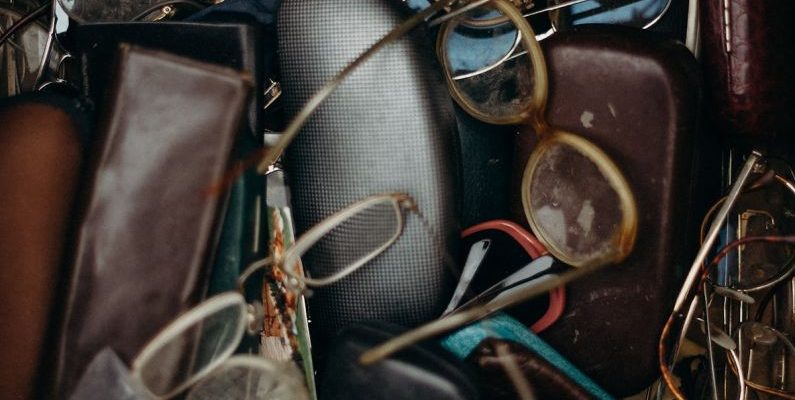 Swap Meet - Black and Brown Leather Bifold Wallet Beside Black Framed Eyeglasses