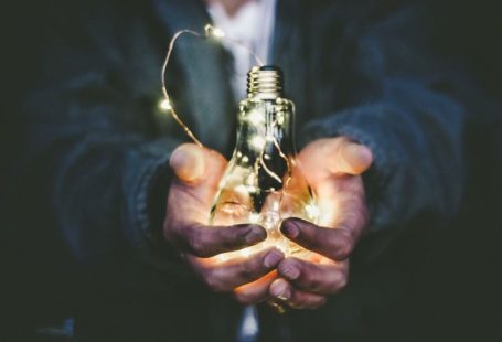 Energy Saving - man holding incandescent bulb