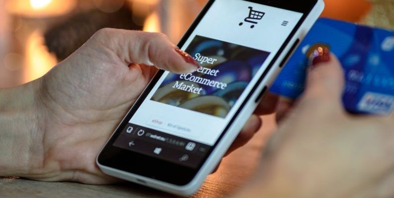 Online Shopping - Person Using Black And White Smartphone and Holding Blue Card