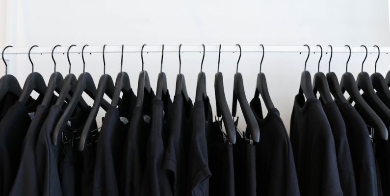 Clothing Shopping - black clothes hanged in rack