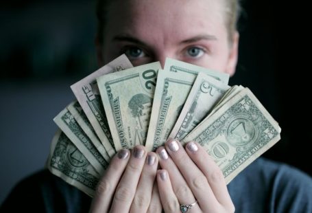 Gift-giving Budget - person holding fan of U.S. dollars banknote