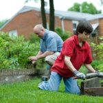 Home Maintenance - man in red polo shirt and blue denim jeans sitting on brown wooden bench during daytime