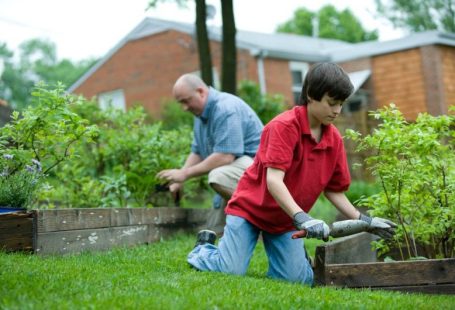 Home Maintenance - man in red polo shirt and blue denim jeans sitting on brown wooden bench during daytime