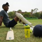 Sports Recreation - man in gray t-shirt and black cap holding white plastic bottle