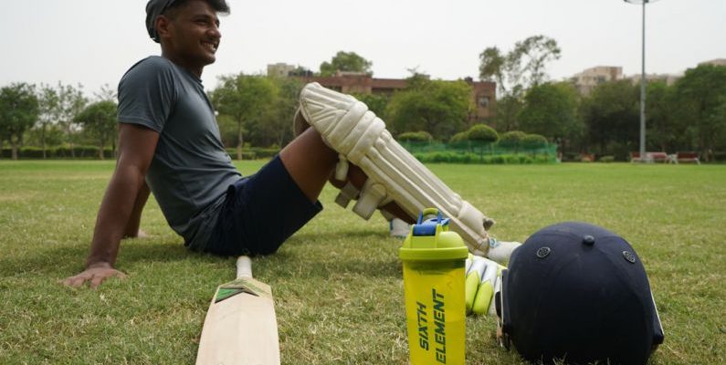 Sports Recreation - man in gray t-shirt and black cap holding white plastic bottle