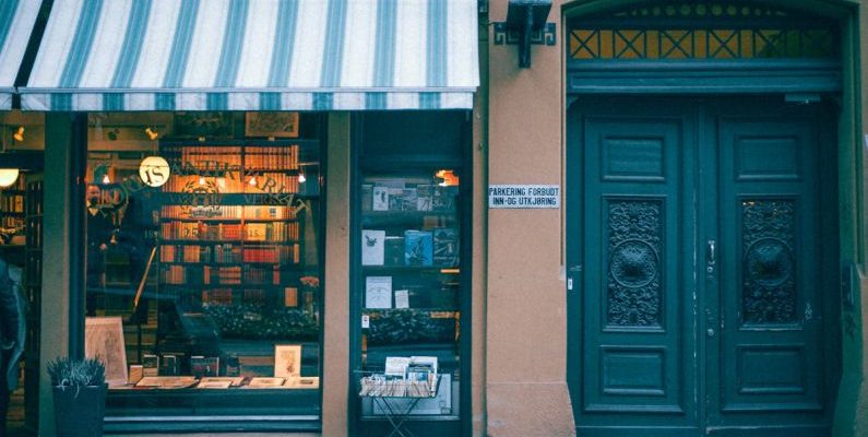 Book Sale - Bookstore building facade on pavement in city