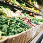 Grocery Coupon - row of vegetables placed on multilayered display fridge