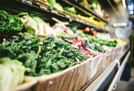 Grocery Coupon - row of vegetables placed on multilayered display fridge