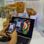 Restaurant Coupon - a person using a cell phone and a laptop on a table