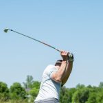 Wholesale Club - man in white tank top and white shorts playing golf during daytime