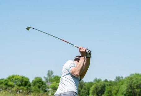 Wholesale Club - man in white tank top and white shorts playing golf during daytime