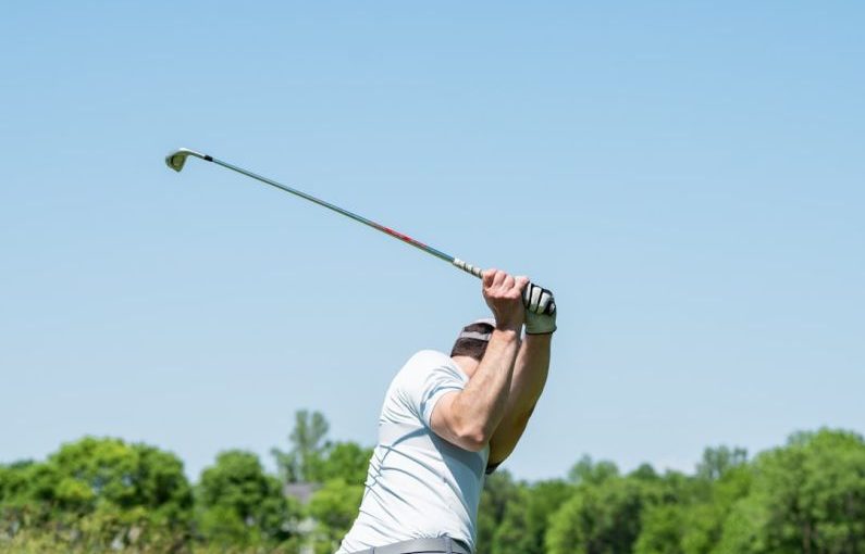 Wholesale Club - man in white tank top and white shorts playing golf during daytime