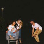 Online Wholesale - woman wearing white shirt riding gray shopping cart