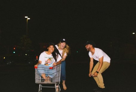 Online Wholesale - woman wearing white shirt riding gray shopping cart