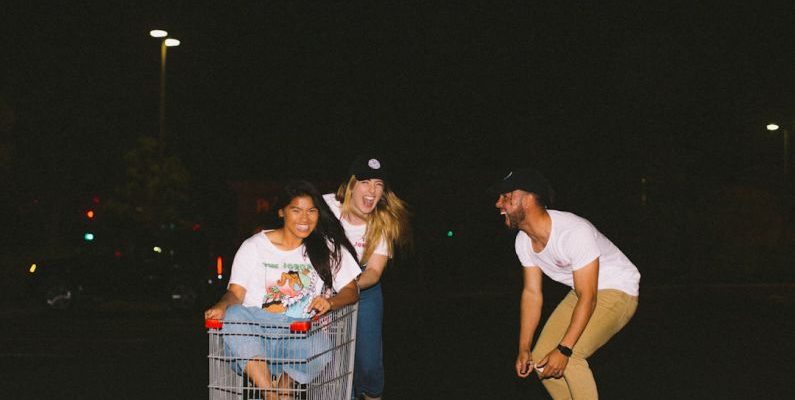 Online Wholesale - woman wearing white shirt riding gray shopping cart