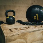 Membership Benefit - black metal kettle bell and heavy bag