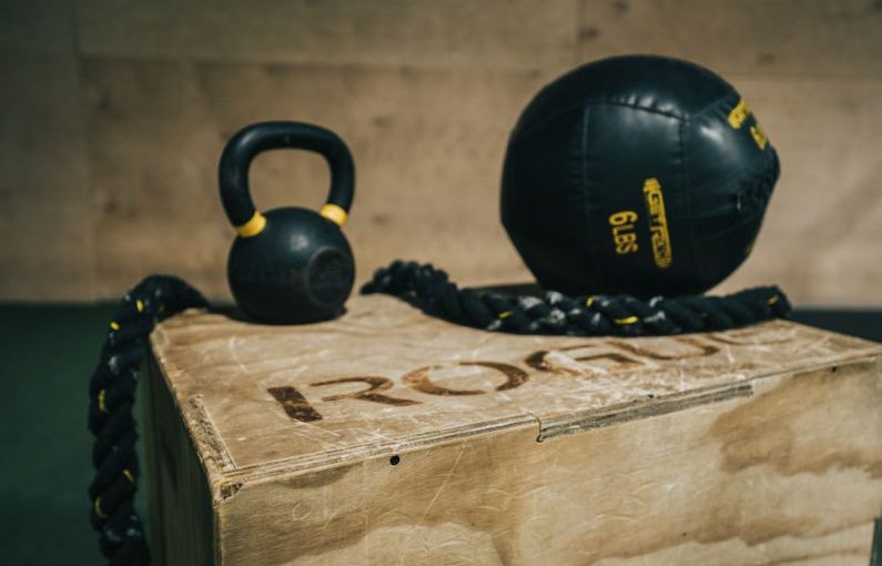 Membership Benefit - black metal kettle bell and heavy bag