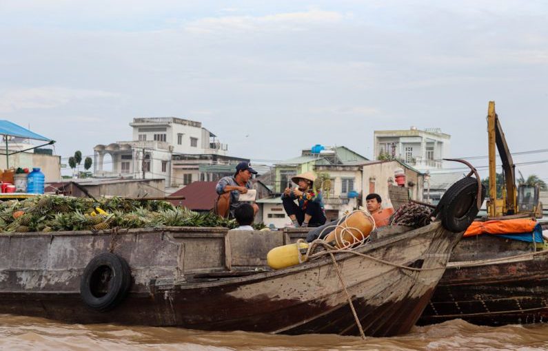 Home Goods Wholesale - a group of people sitting on top of a wooden boat