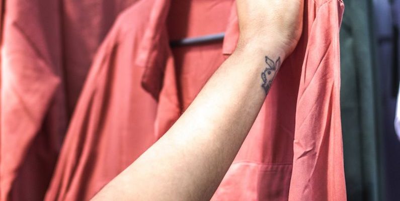 Thrift Finds - Person Holding Red Dress Shirt on Hanger