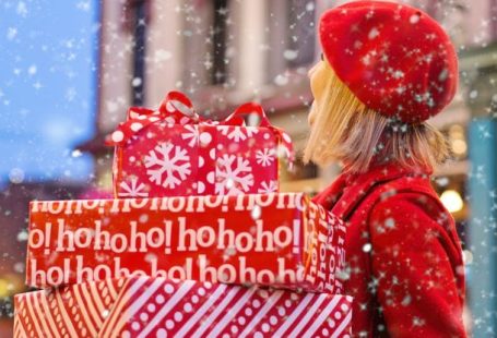 Off-season Shopping - Woman Holding Three Red Christmas Presents Boxes