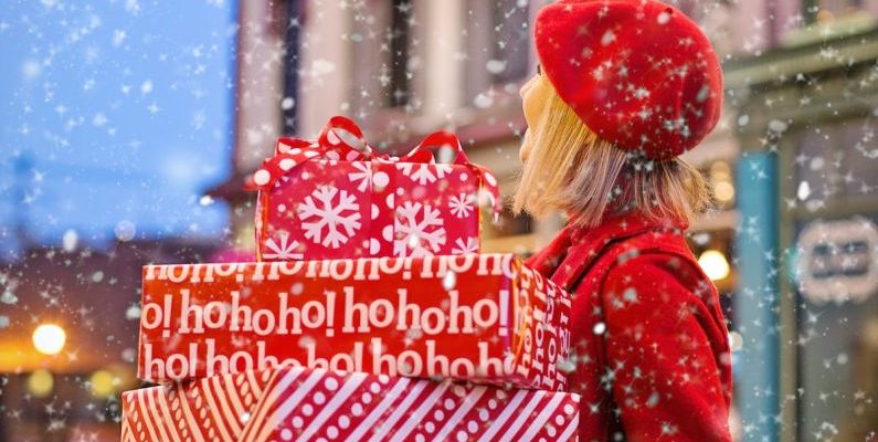 Off-season Shopping - Woman Holding Three Red Christmas Presents Boxes