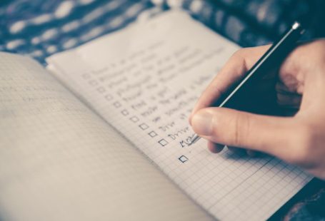 Grocery List - person writing bucket list on book