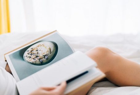 Weeknight Recipes - person holding open magazine while laying on bed