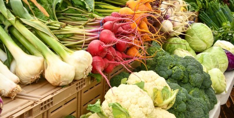 Farmer's Market - green and red vegetable on brown wooden table