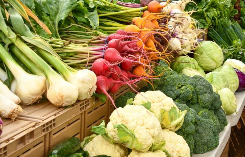 Farmer's Market - green and red vegetable on brown wooden table