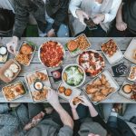 Family Meal - a group of people sitting around a table with food