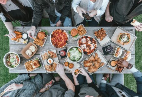 Family Meal - a group of people sitting around a table with food