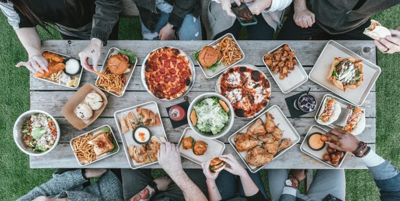 Family Meal - a group of people sitting around a table with food