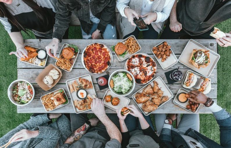 Family Meal - a group of people sitting around a table with food